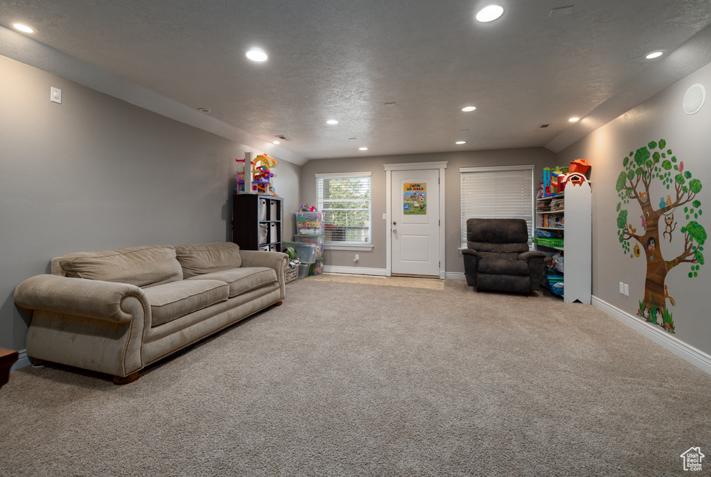 Living area with carpet flooring, recessed lighting, and baseboards