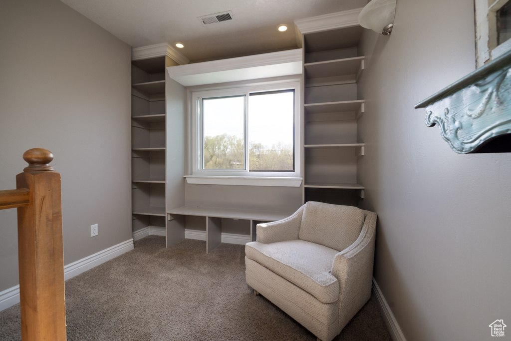 Living area with carpet floors, baseboards, recessed lighting, and visible vents