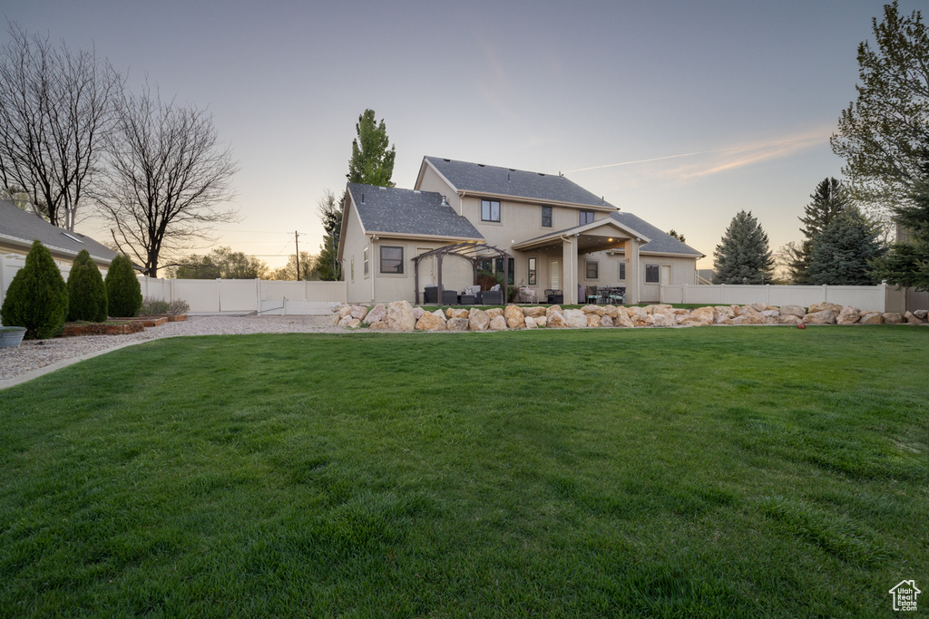 Exterior space featuring a fenced backyard and a yard