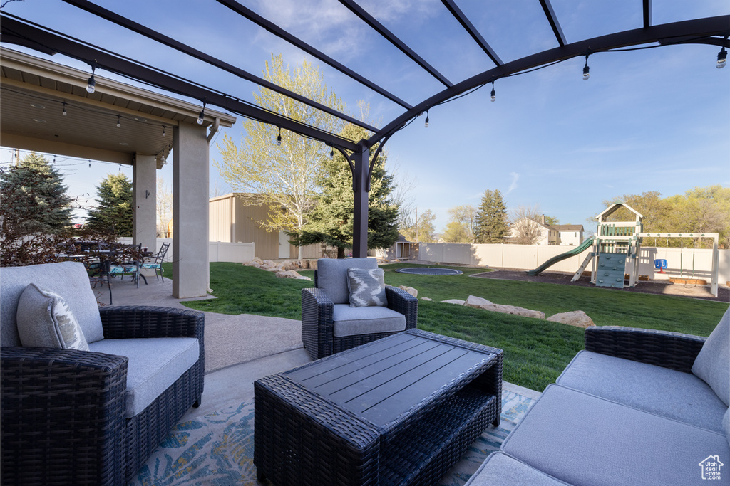 View of patio featuring a pergola, a fenced backyard, an outdoor hangout area, a playground, and outdoor dining space
