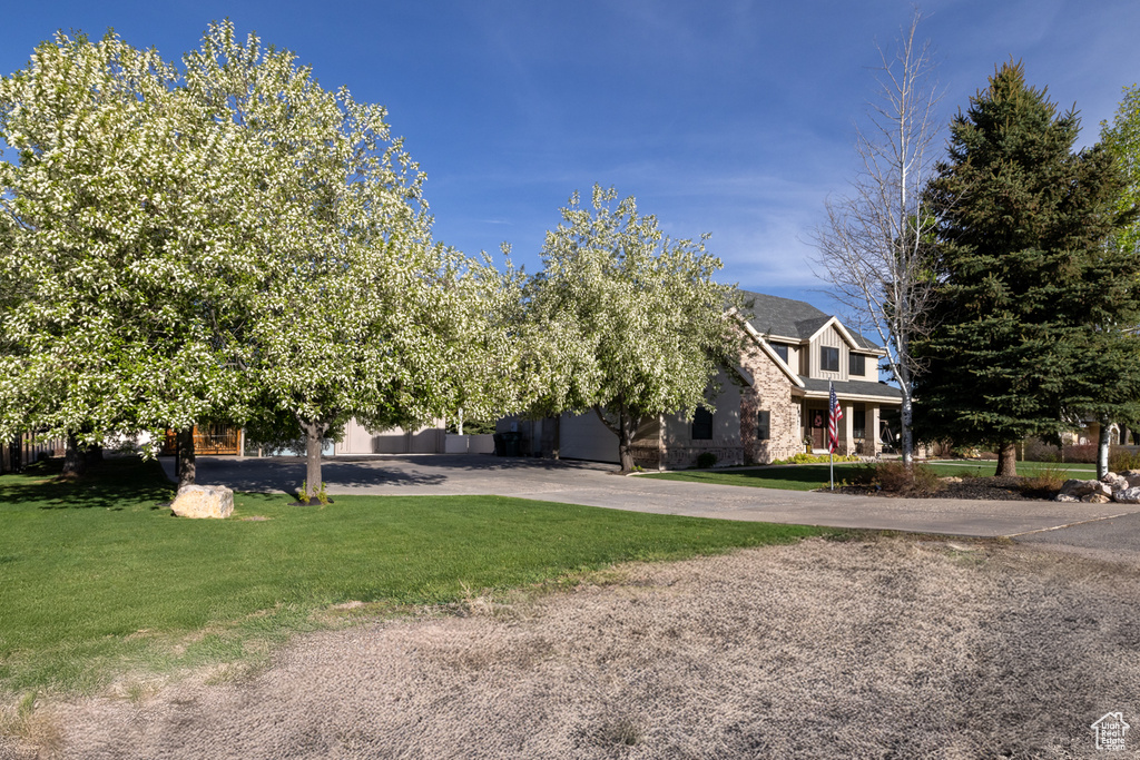 View of front of property with stone siding and a front lawn