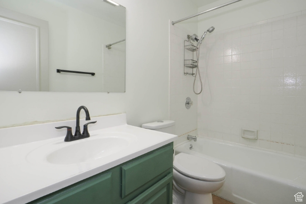 Bathroom featuring toilet, bathing tub / shower combination, and vanity