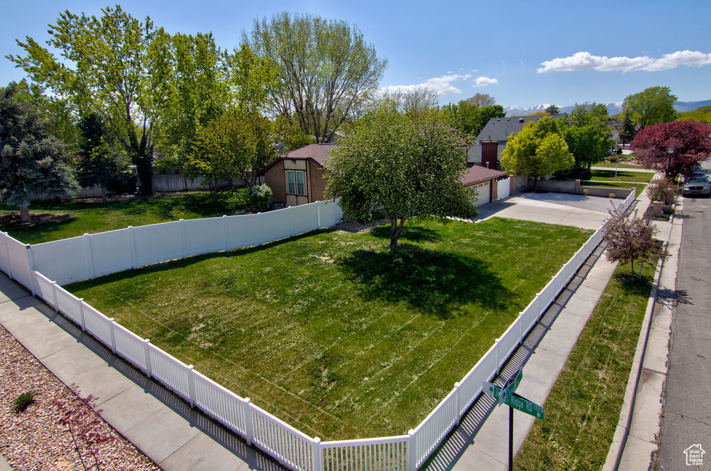 View of yard featuring fence private yard and a garage