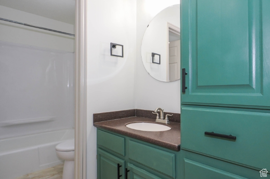 Full bathroom with shower / bathtub combination, toilet, and vanity