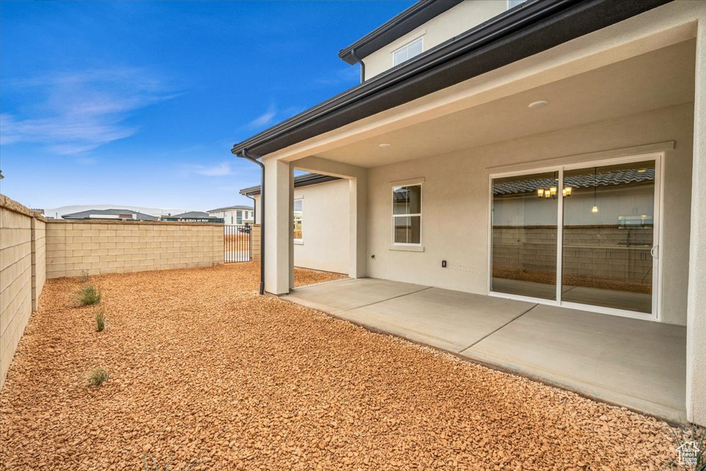 View of yard with a fenced backyard and a patio