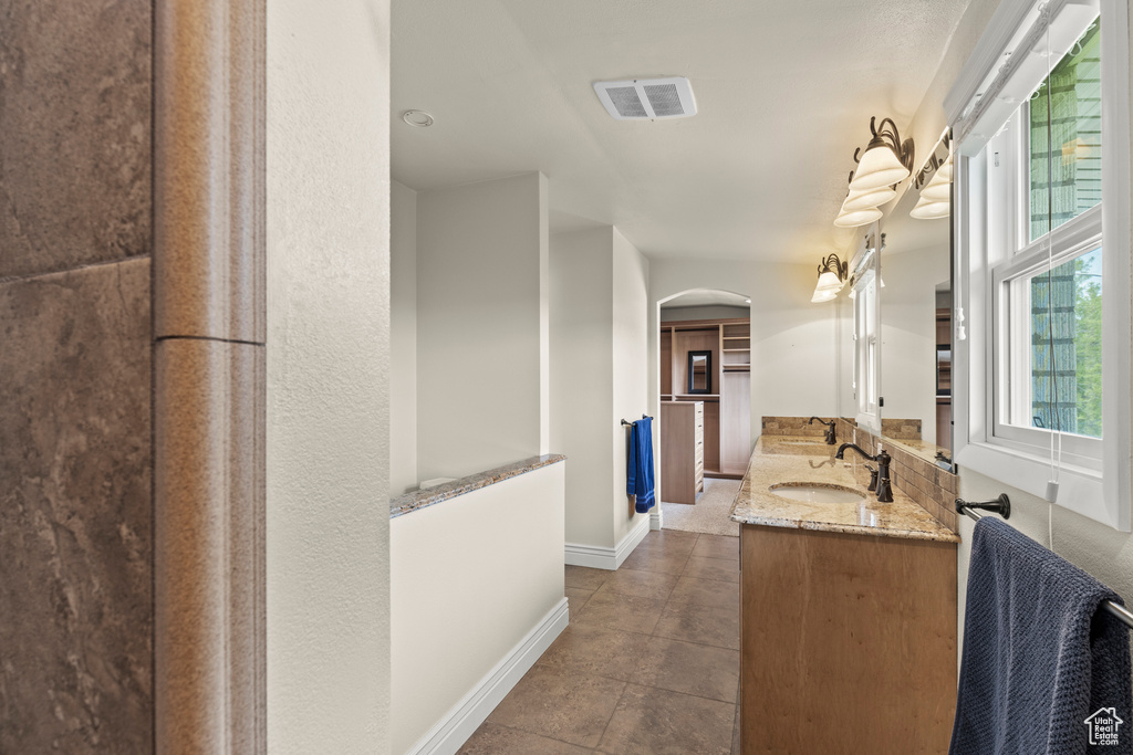 Bathroom featuring baseboards, vanity, and visible vents