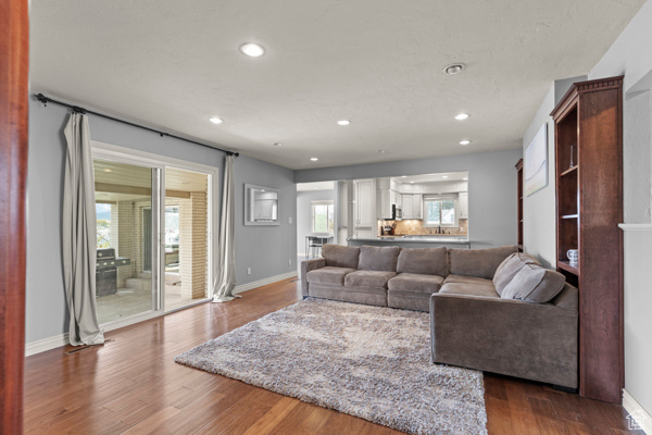 Living area featuring recessed lighting, dark wood finished floors, and baseboards