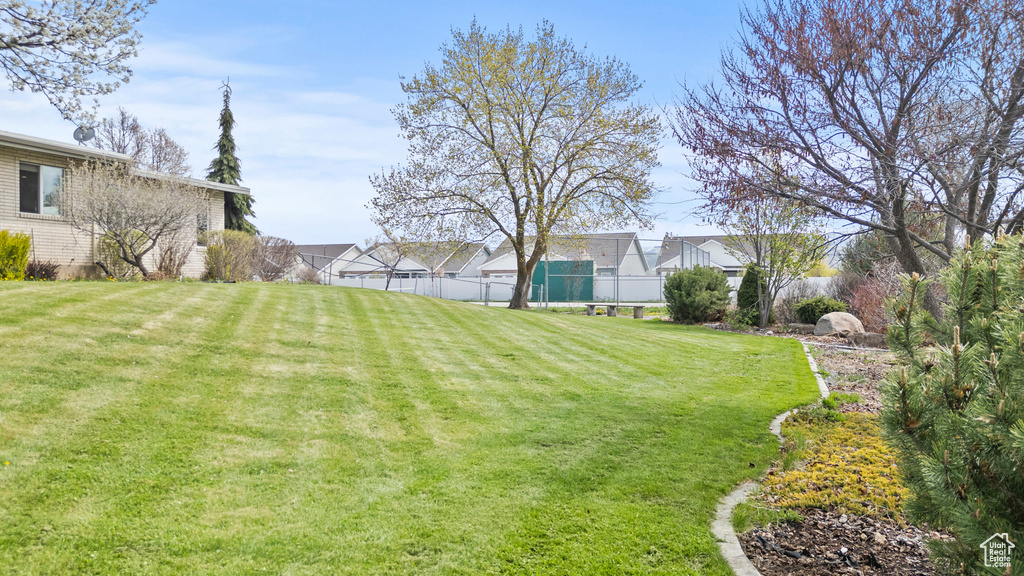 View of yard featuring fence and a residential view