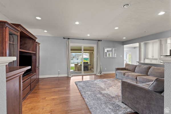 Living area featuring recessed lighting, baseboards, light wood finished floors, and a healthy amount of sunlight
