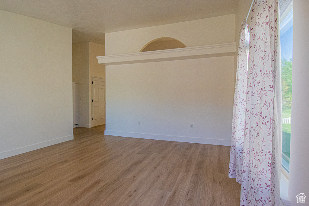 Unfurnished room with baseboards and light wood-style flooring