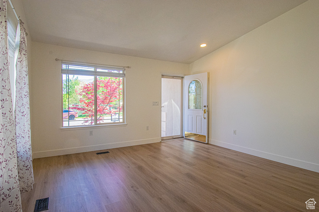Interior space featuring baseboards, recessed lighting, wood finished floors, and visible vents