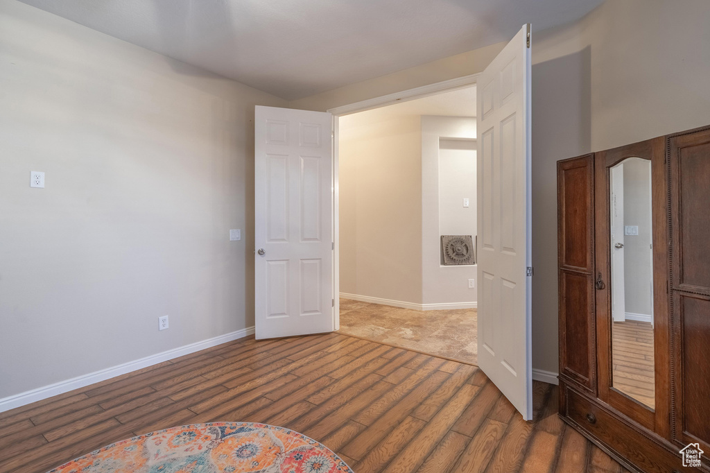 Empty room with baseboards and wood finished floors