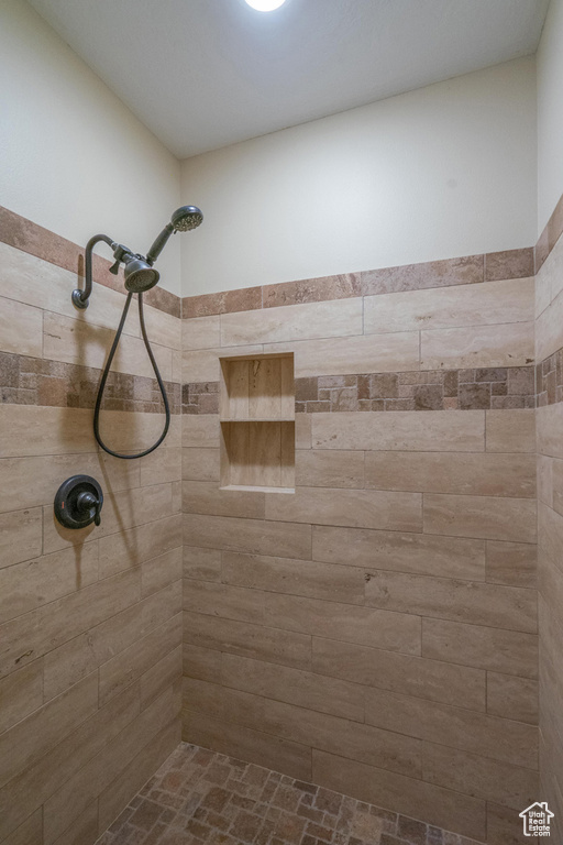 Full bathroom with a tile shower