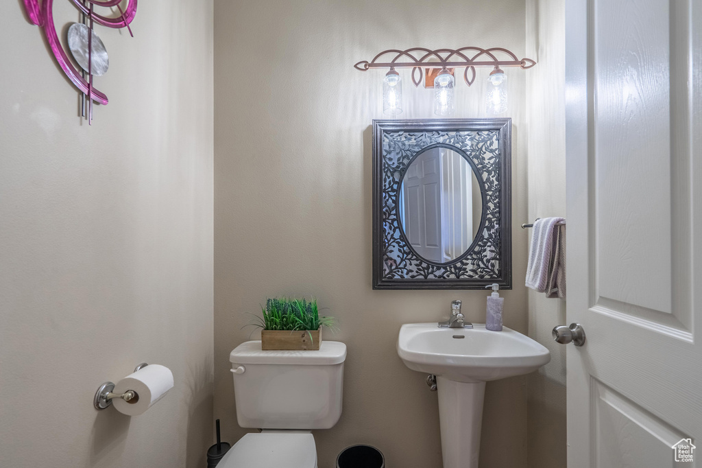 Half bathroom featuring toilet and a sink