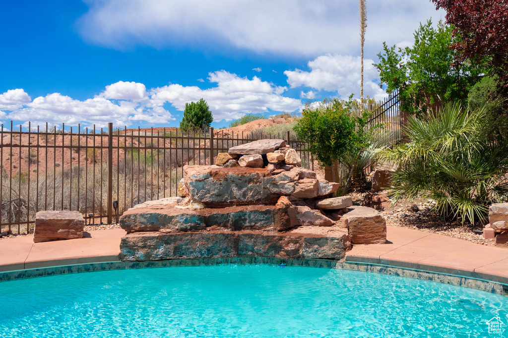 View of pool featuring a fenced in pool and fence