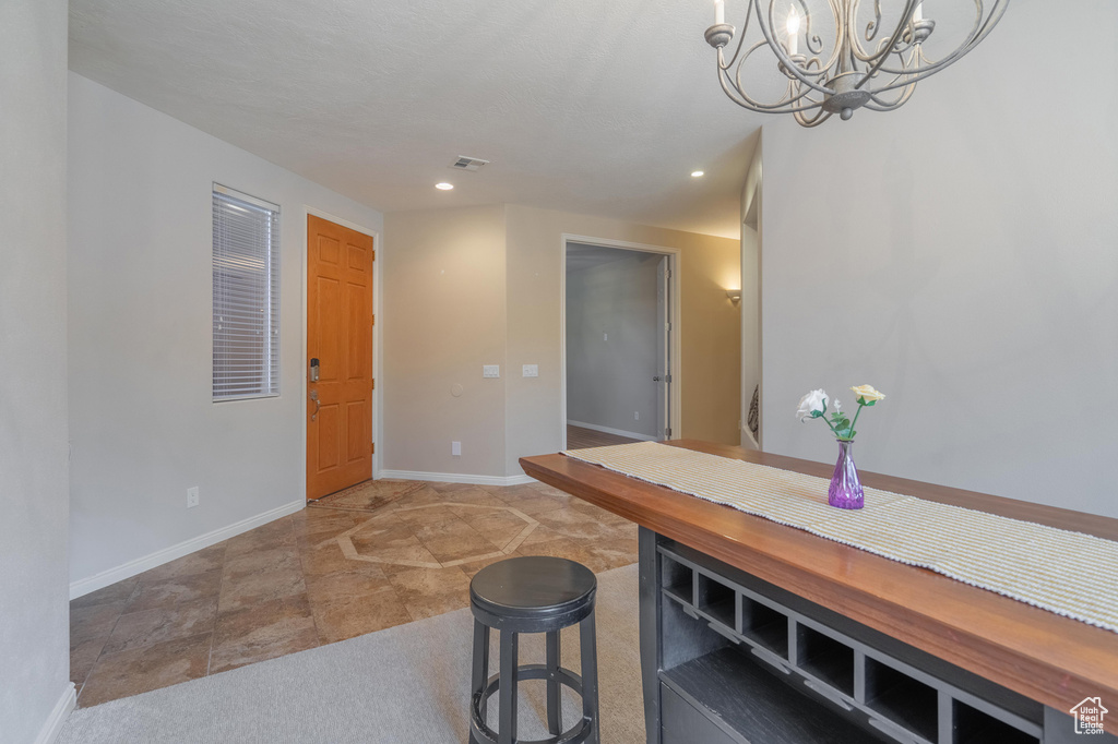 Unfurnished dining area featuring recessed lighting, baseboards, an inviting chandelier, and visible vents