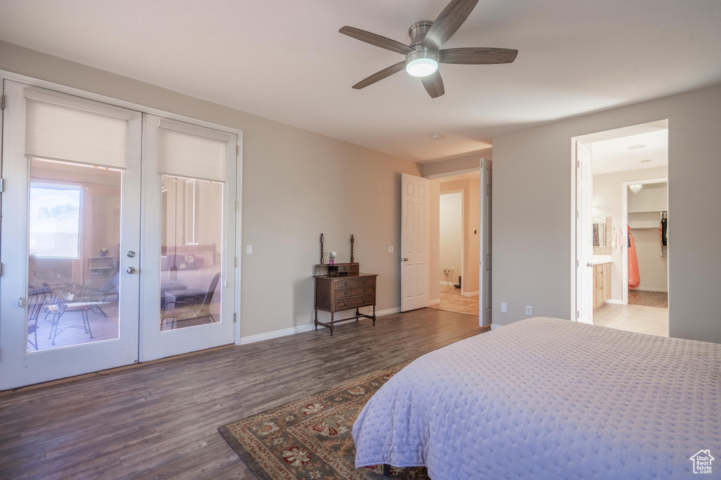 Bedroom with access to outside, french doors, baseboards, ensuite bathroom, and wood finished floors