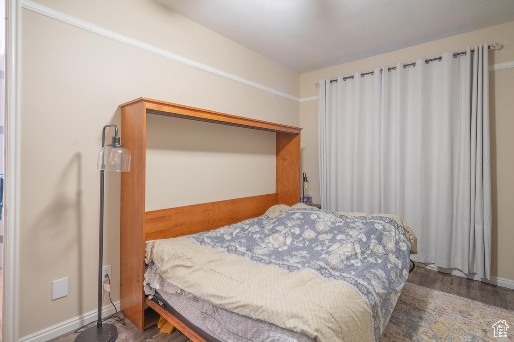 Bedroom featuring baseboards and wood finished floors