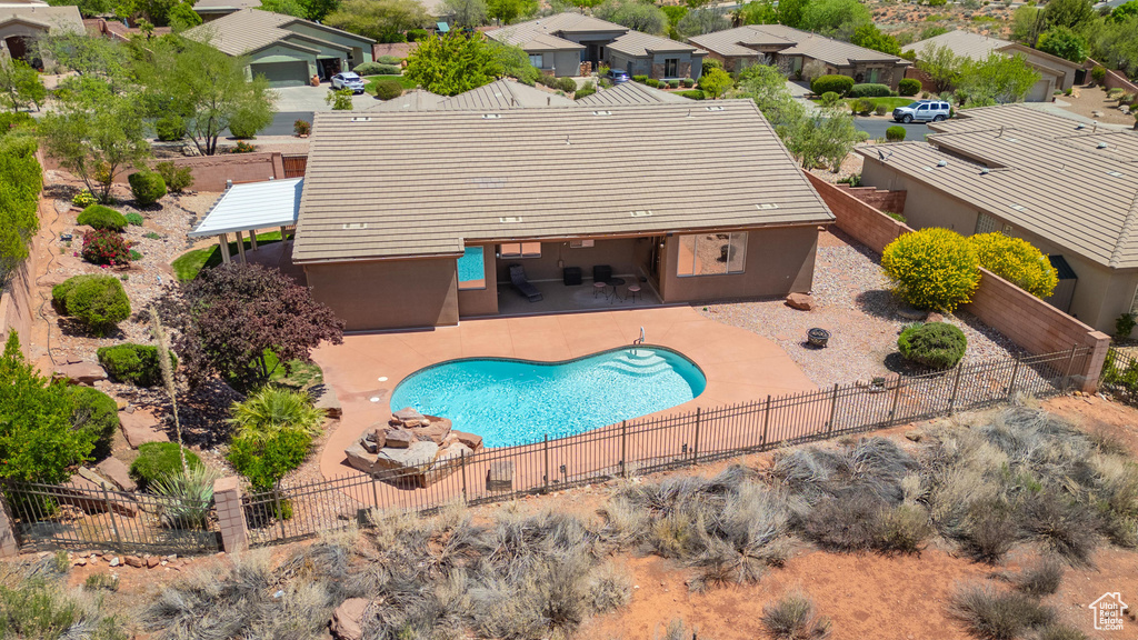 View of pool with a residential view, a fenced in pool, a fenced backyard, and a patio area