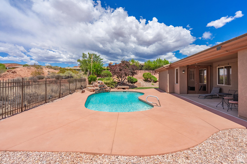 View of pool with fence, a patio area, and a fenced in pool