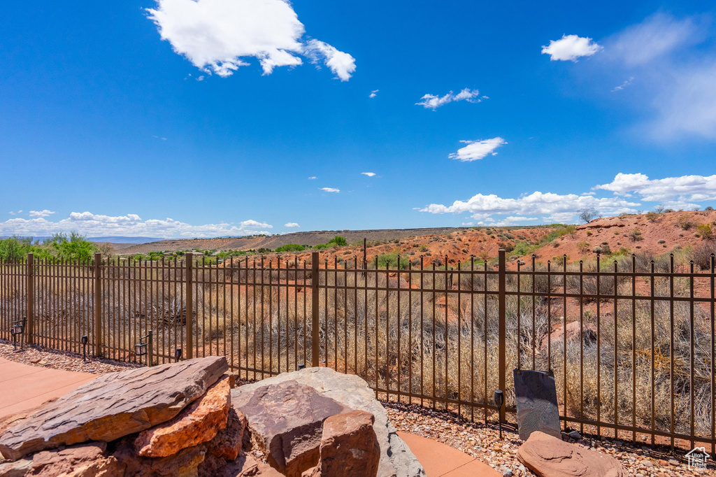 View of yard featuring fence and a mountain view
