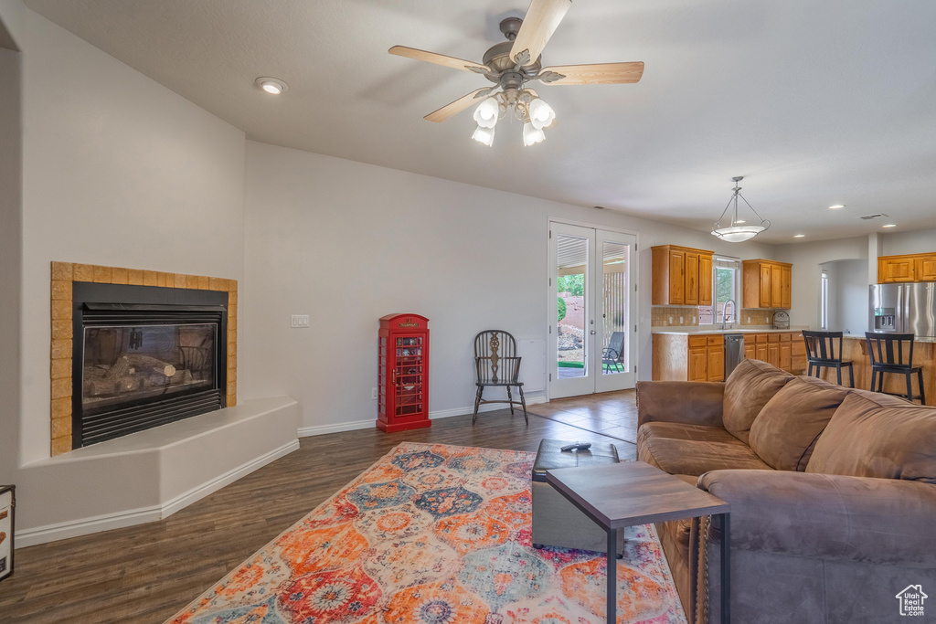 Living room featuring recessed lighting, baseboards, a ceiling fan, and dark wood-style flooring