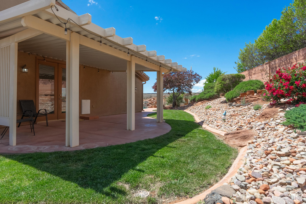 View of yard with a fenced backyard and a patio