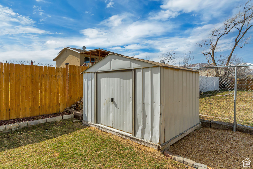 View of shed featuring a fenced backyard