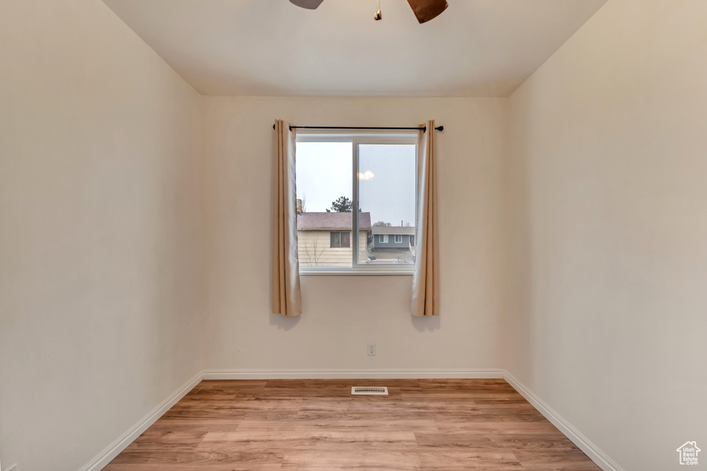 Unfurnished room featuring ceiling fan and light wood-type flooring
