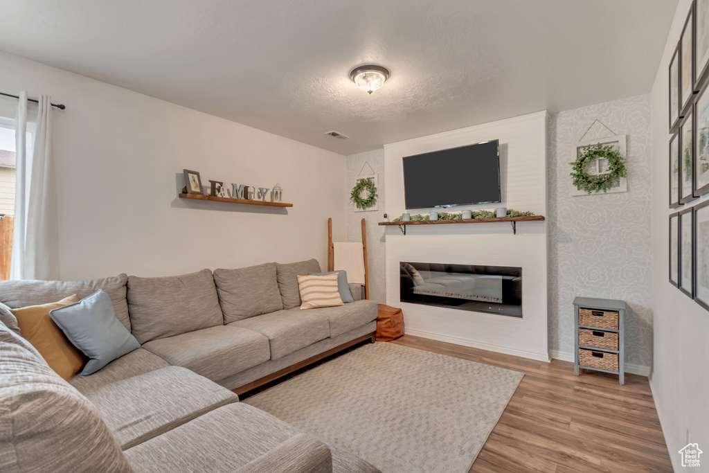 Living room featuring a fireplace and light wood-type flooring