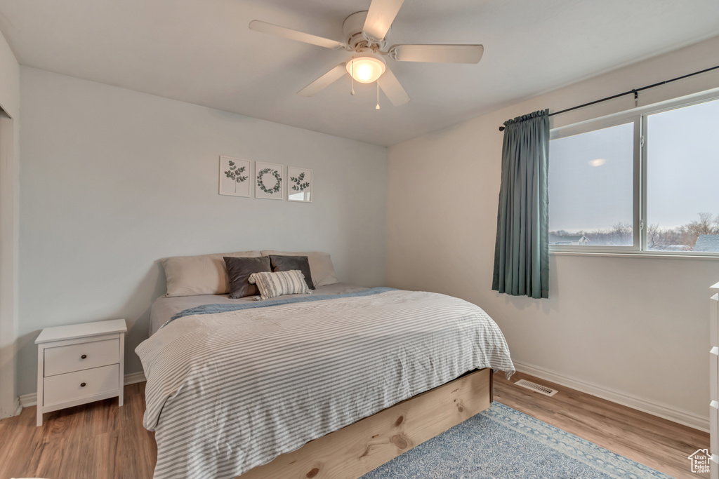 Bedroom featuring ceiling fan and light hardwood / wood-style flooring