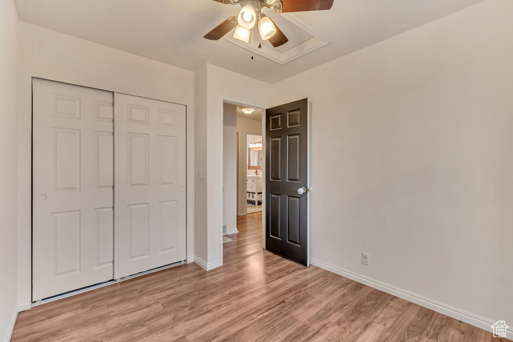 Unfurnished bedroom with light hardwood / wood-style flooring, a closet, and ceiling fan