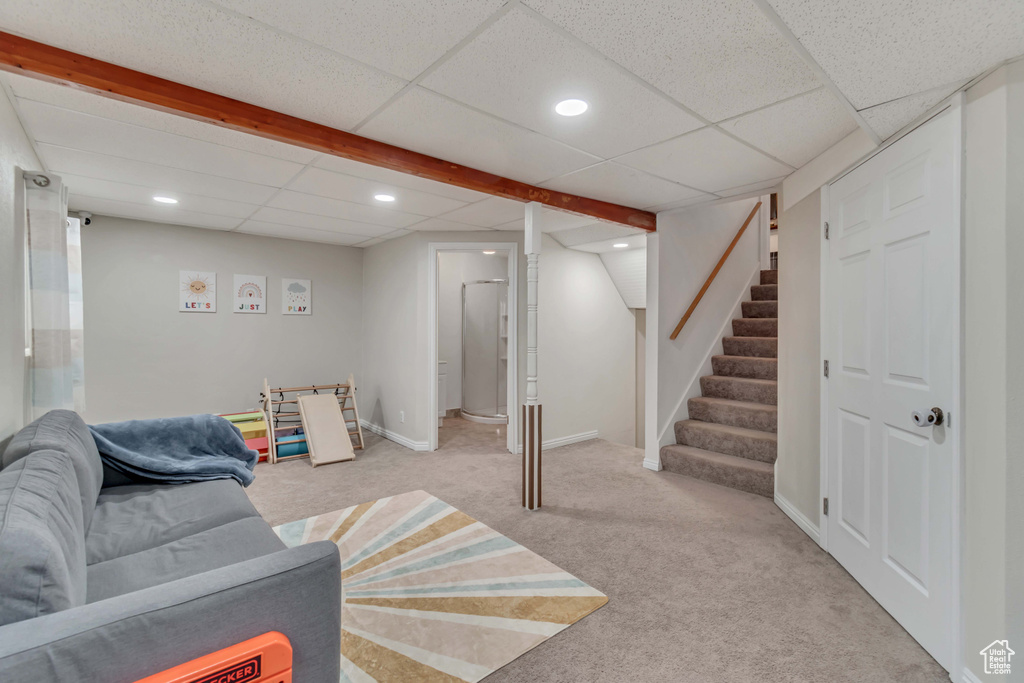 Carpeted living room with a drop ceiling