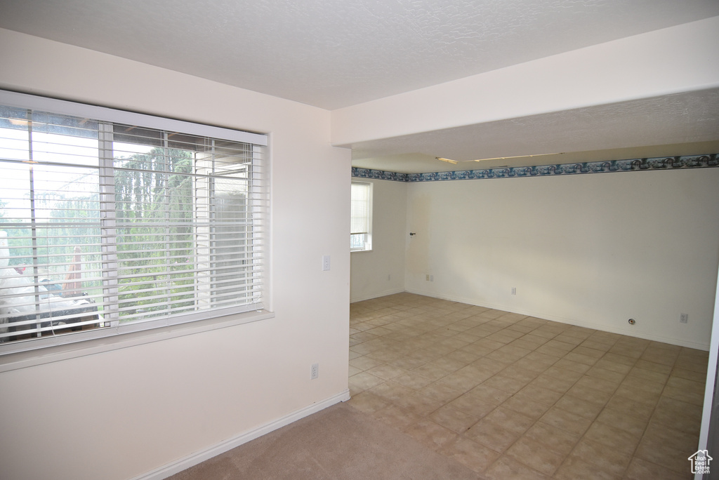 Empty room featuring plenty of natural light and baseboards