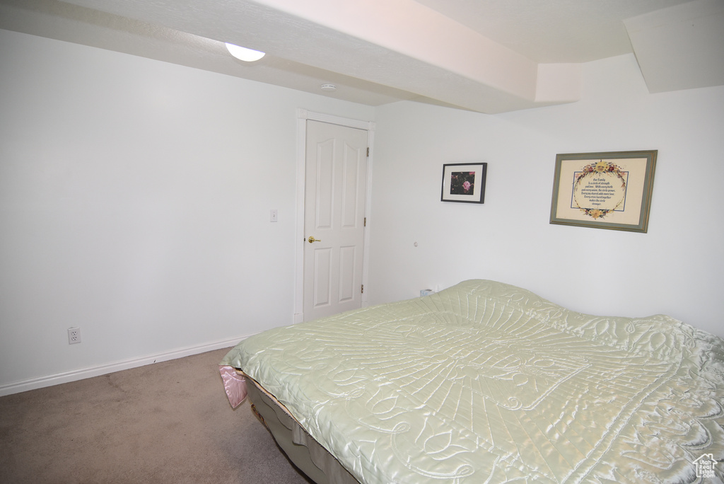 Bedroom with carpet flooring and baseboards