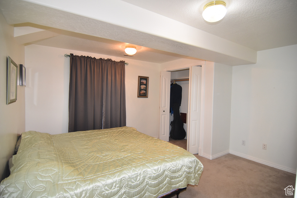 Carpeted bedroom with baseboards