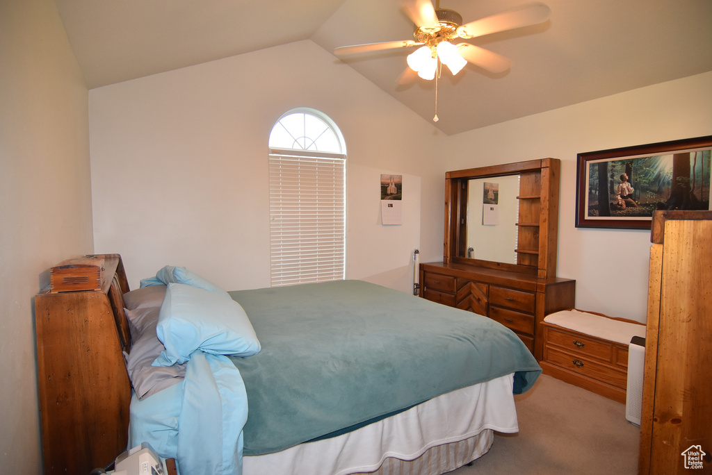 Bedroom featuring vaulted ceiling, carpet floors, and ceiling fan