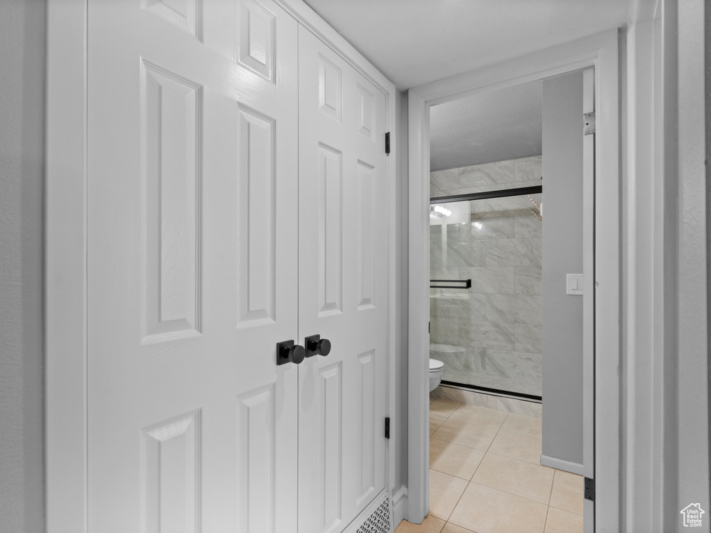Hallway with light tile patterned flooring