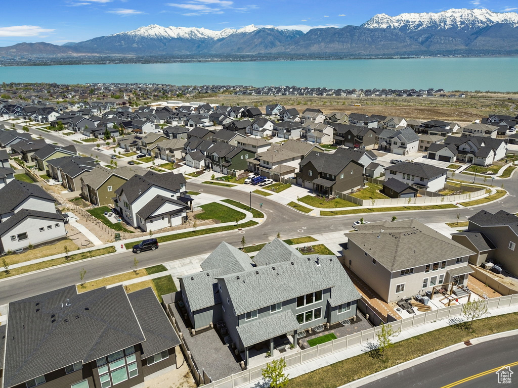Drone / aerial view with a water and mountain view and a residential view