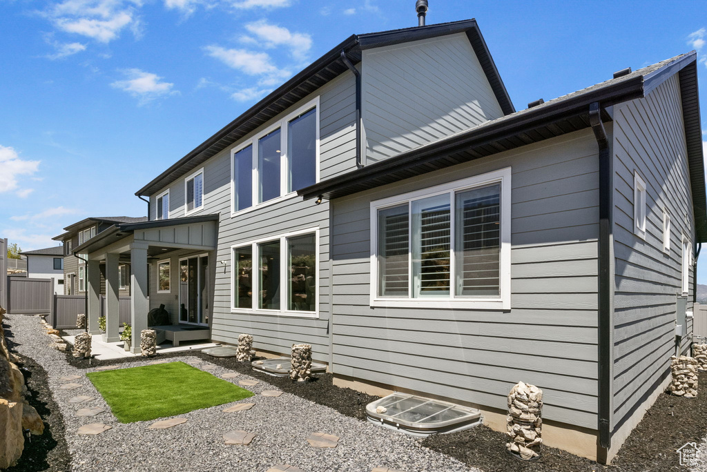 Rear view of house featuring fence
