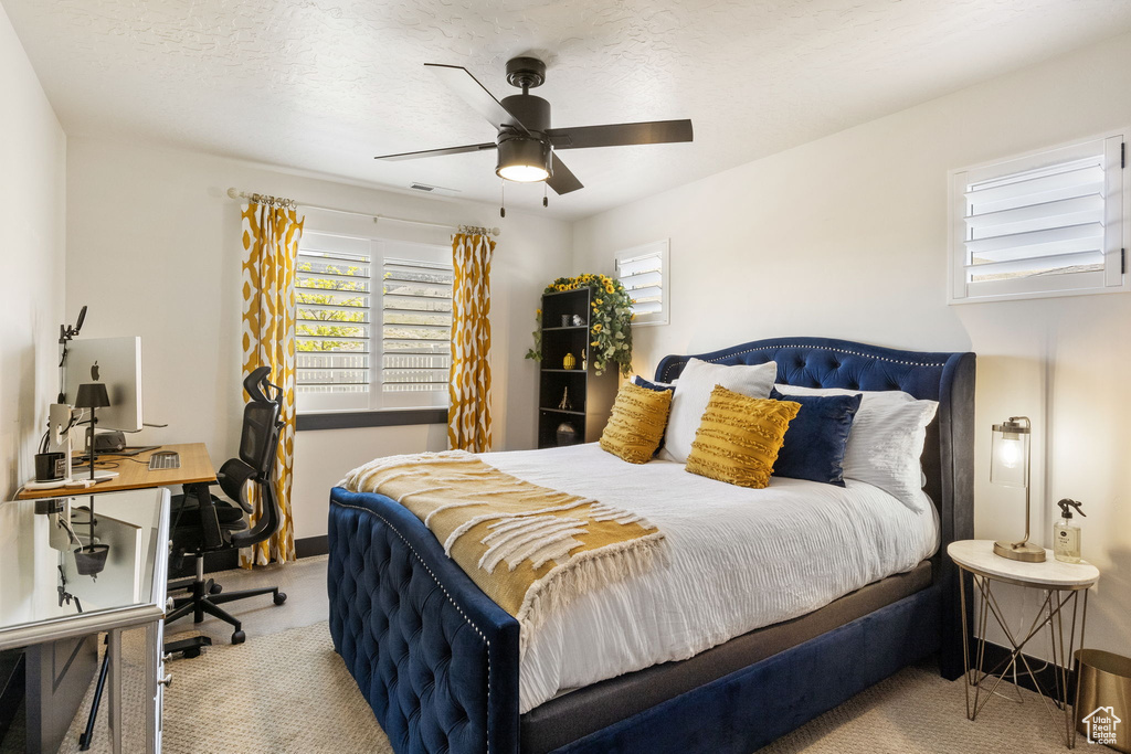 Bedroom with baseboards, visible vents, and ceiling fan