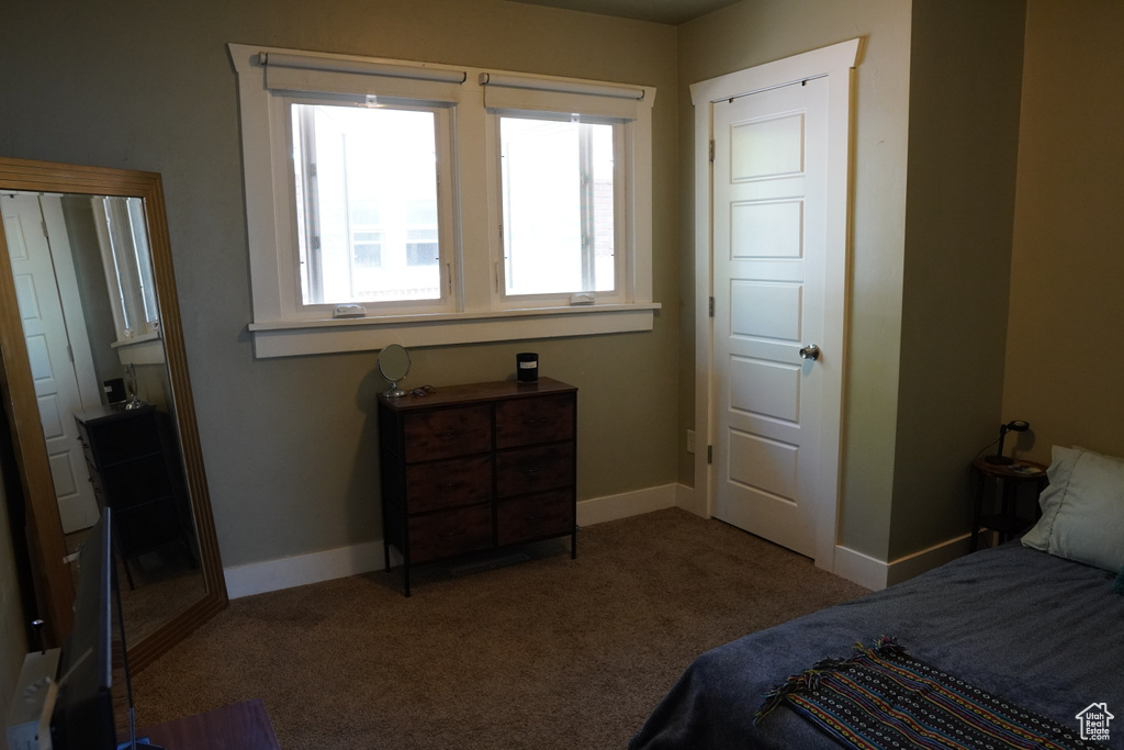 Carpeted bedroom featuring baseboards