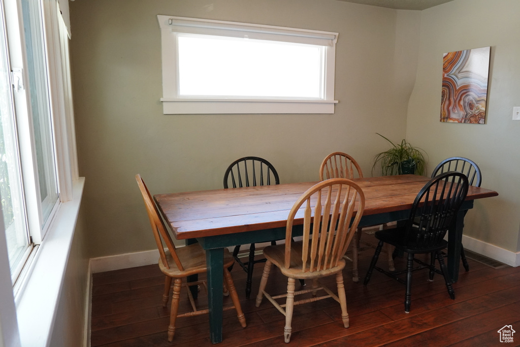 Dining room with baseboards and hardwood / wood-style flooring