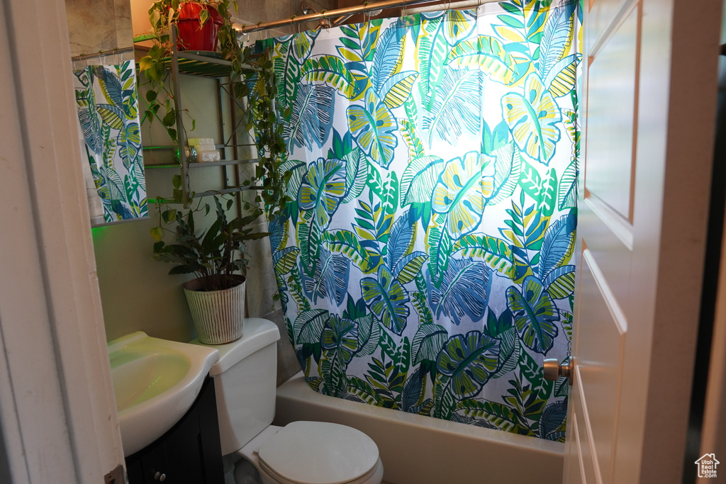 Full bath with toilet, shower / bath combination with curtain, and vanity