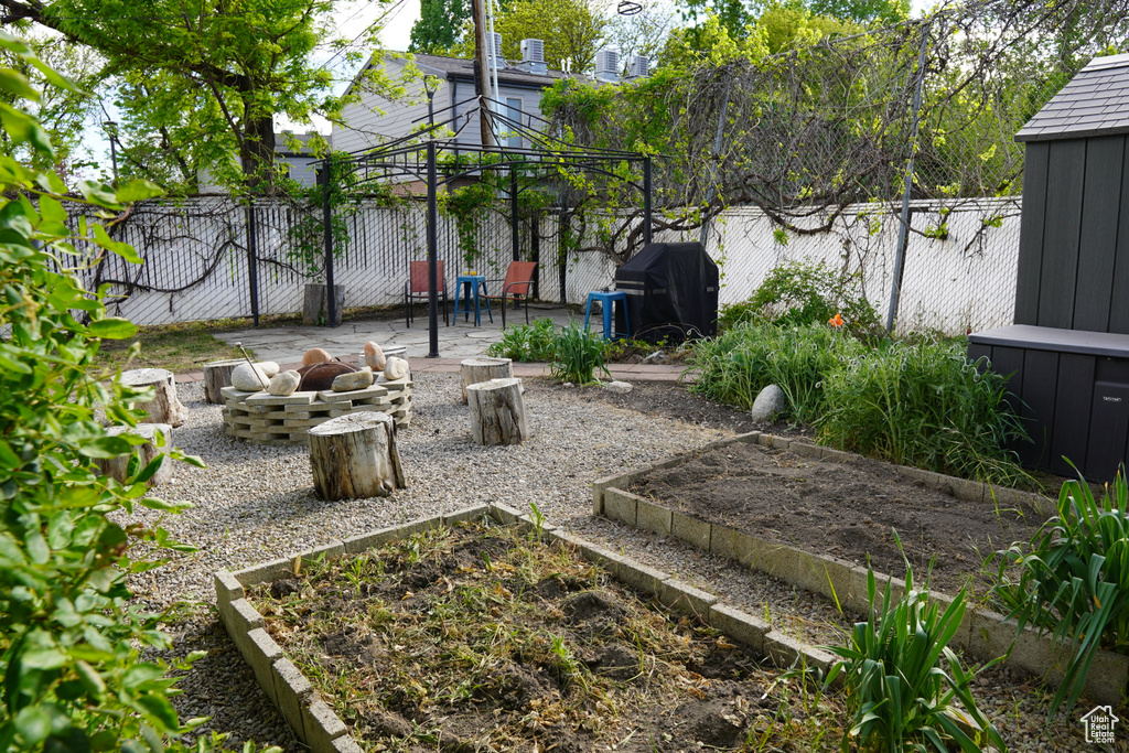 View of yard featuring a gazebo, a fenced backyard, a patio area, and a vegetable garden
