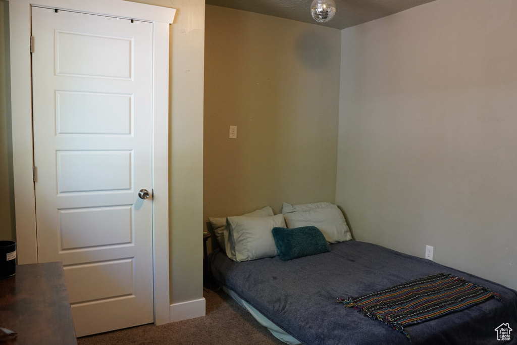 Carpeted bedroom featuring baseboards