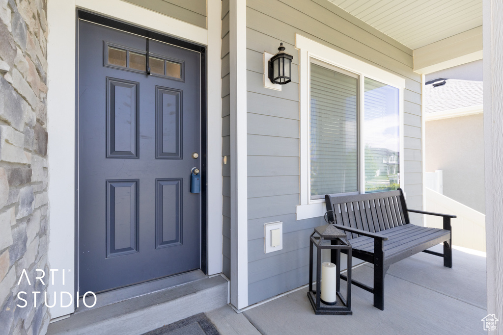 Doorway to property featuring a porch