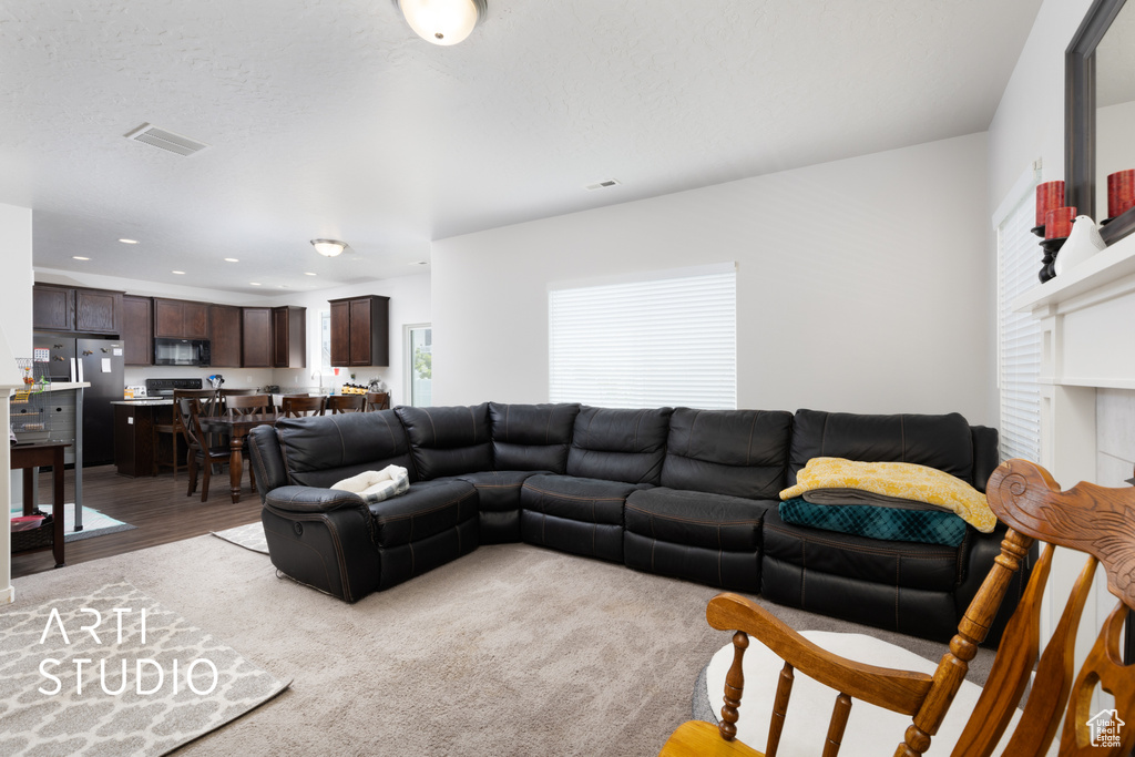 Living room featuring light wood-style floors and recessed lighting