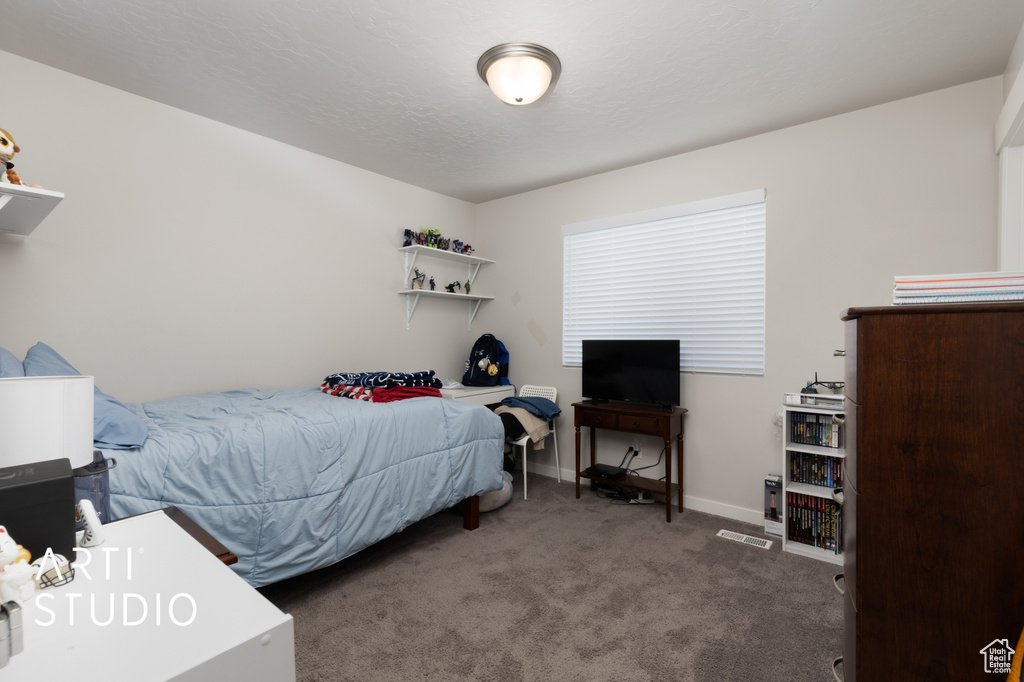 Bedroom with carpet flooring and baseboards
