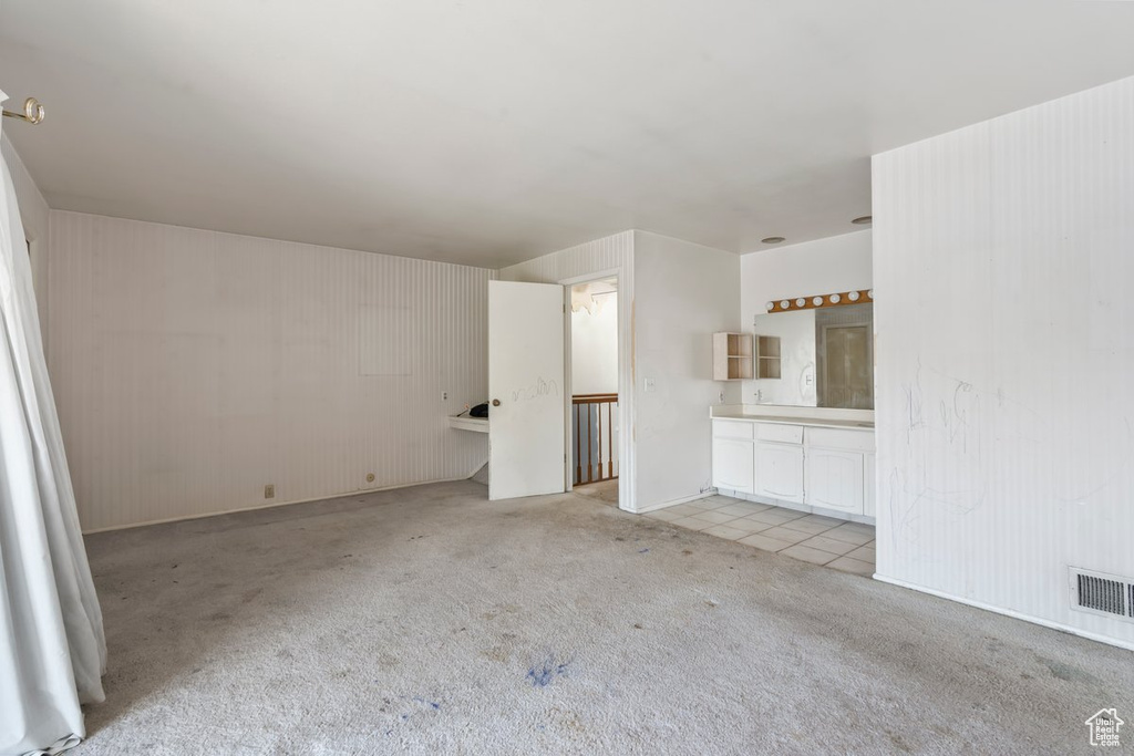 Unfurnished living room featuring light carpet and visible vents